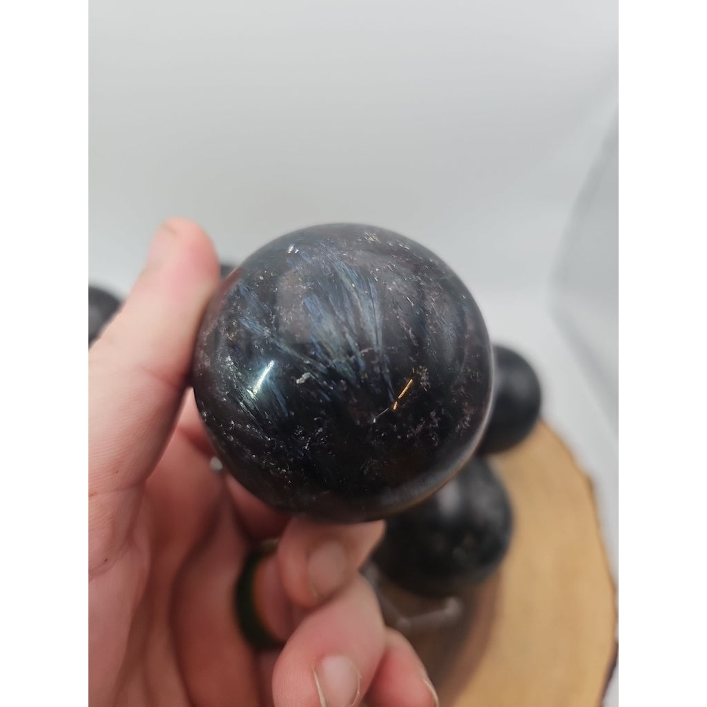 Quartz Crystal Sphere 50mm 1 Each Arfvedsonite Garnet Flash by CrystalCloud Company