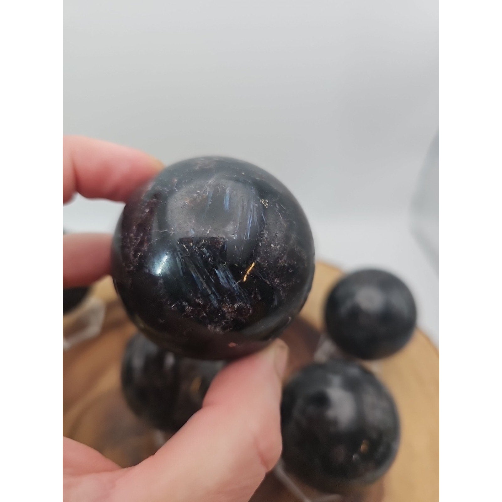Quartz Crystal Sphere 50mm 1 Each Arfvedsonite Garnet Flash by CrystalCloud Company