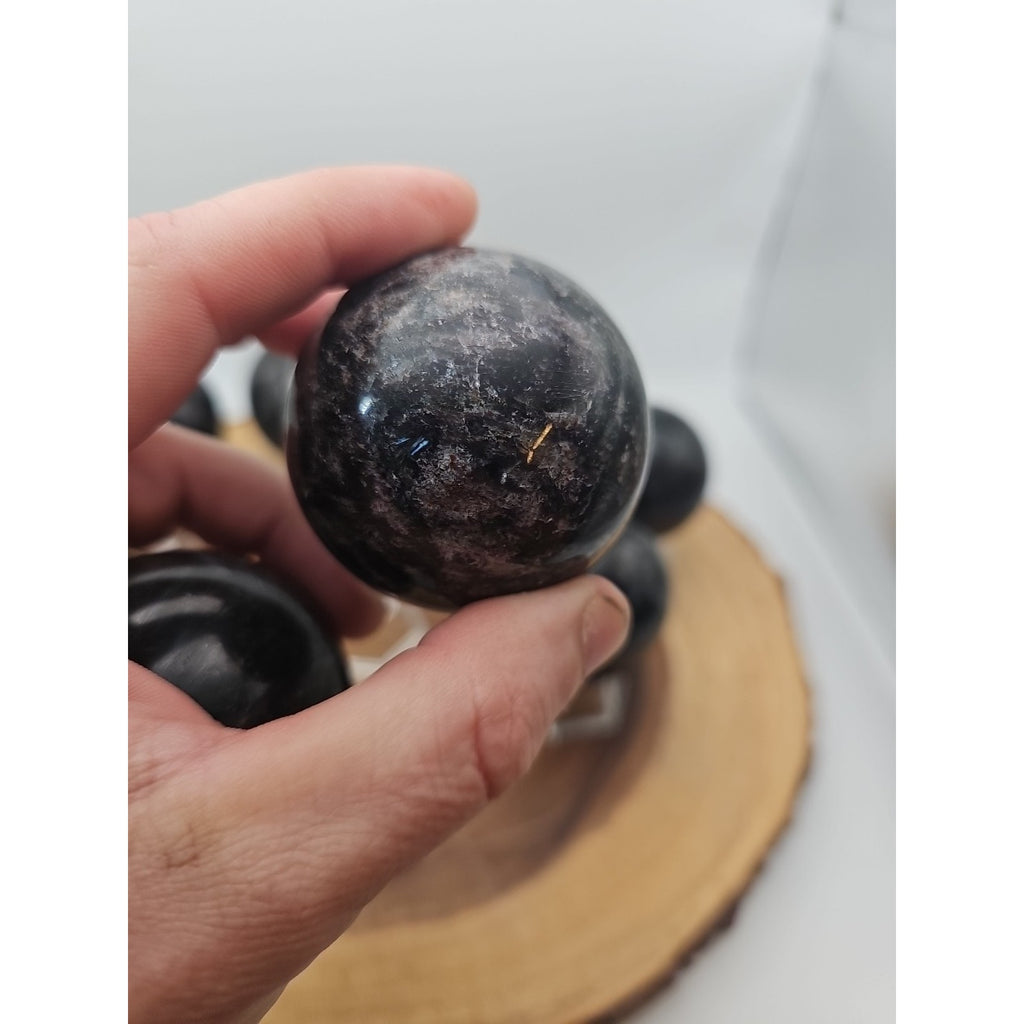 Quartz Crystal Sphere 50mm 1 Each Arfvedsonite Garnet Flash by CrystalCloud Company